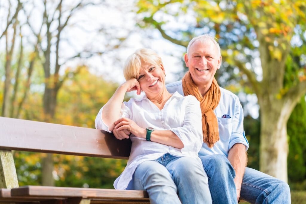 Senior couple sitting together on a bench